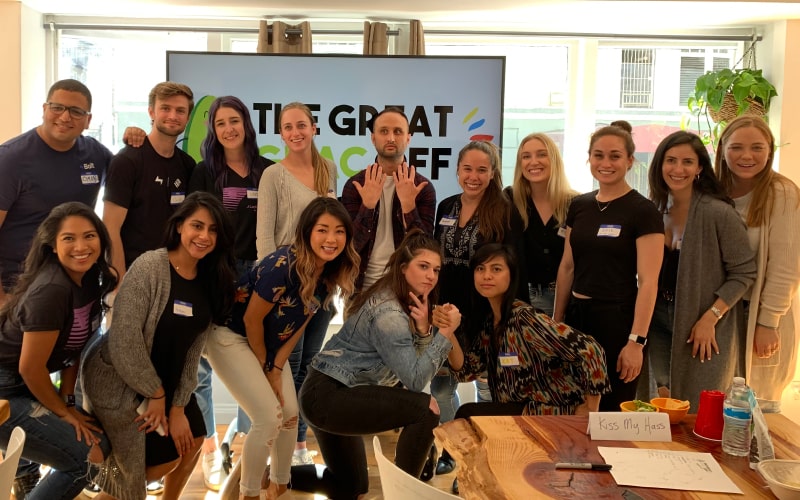 Happy staff posing together at the end of a corporate event.