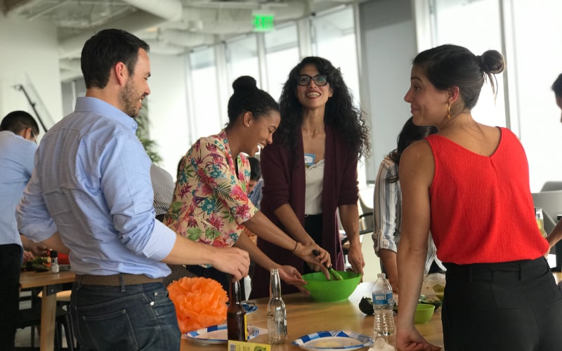 Group of employees making guacamole together as a fun team bonding activity.